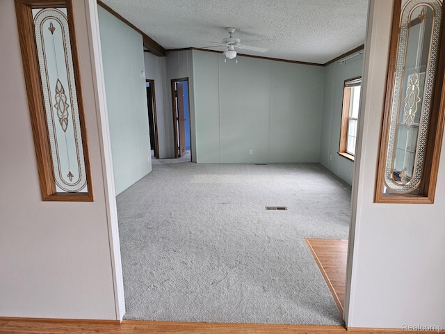 73 Grey Fox Ct, Grand Blanc, MI 48439 - carpeted spare room with a ceiling fan, a textured ceiling, and ornamental molding
