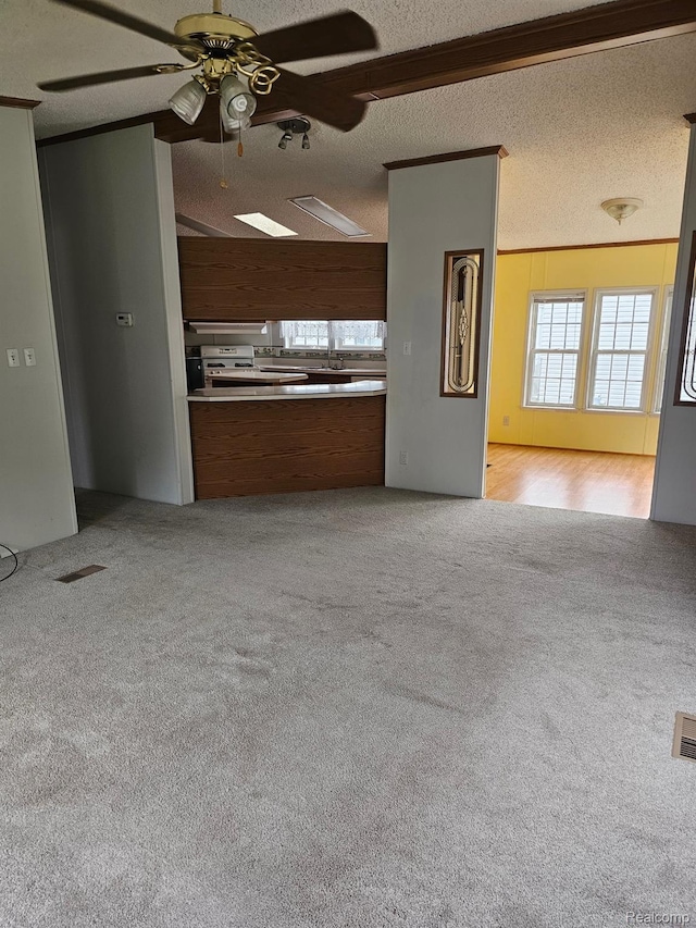 73 Grey Fox Ct, Grand Blanc, MI 48439 - unfurnished living room featuring light carpet, a ceiling fan, and a textured ceiling