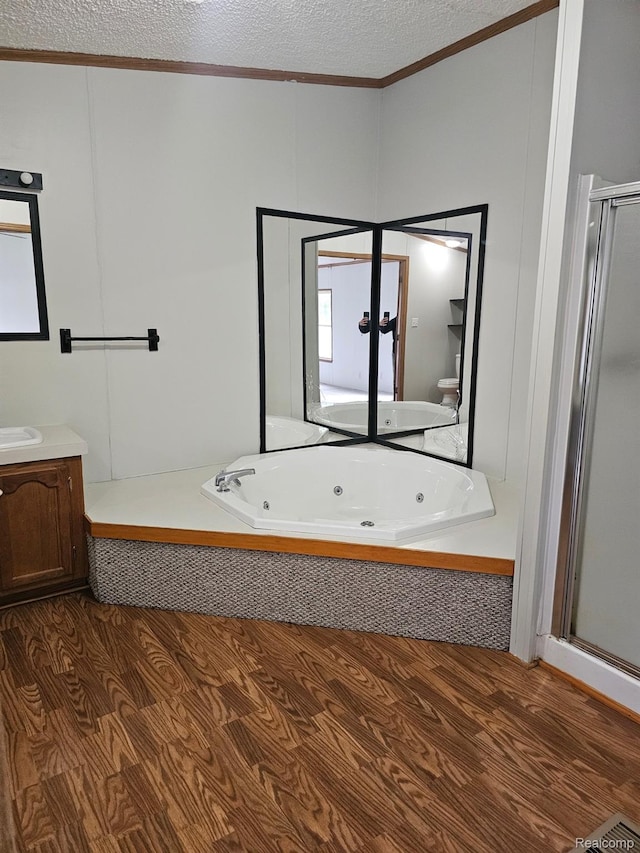 73 Grey Fox Ct, Grand Blanc, MI 48439 - bathroom with ornamental molding, vanity, a shower stall, a jetted tub, and a textured ceiling