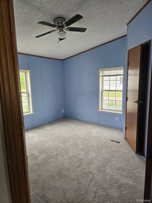 73 Grey Fox Ct, Grand Blanc, MI 48439 - unfurnished room featuring crown molding, carpet, a ceiling fan, a textured ceiling, and vaulted ceiling
