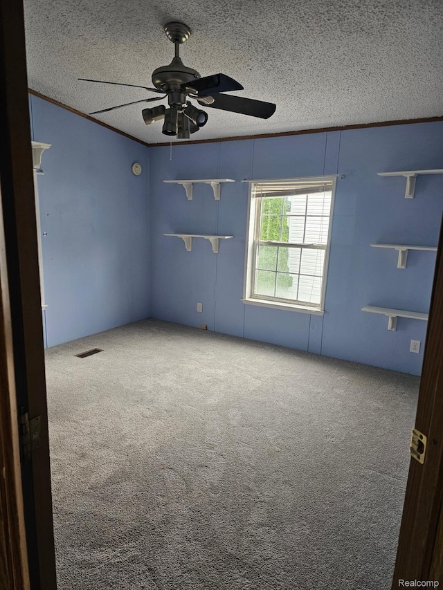 73 Grey Fox Ct, Grand Blanc, MI 48439 - spare room with a textured ceiling, carpet, a ceiling fan, and crown molding