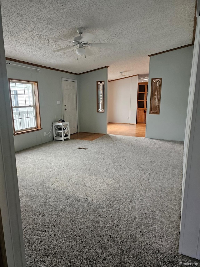 73 Grey Fox Ct, Grand Blanc, MI 48439 - carpeted empty room featuring crown molding, ceiling fan, and a textured ceiling