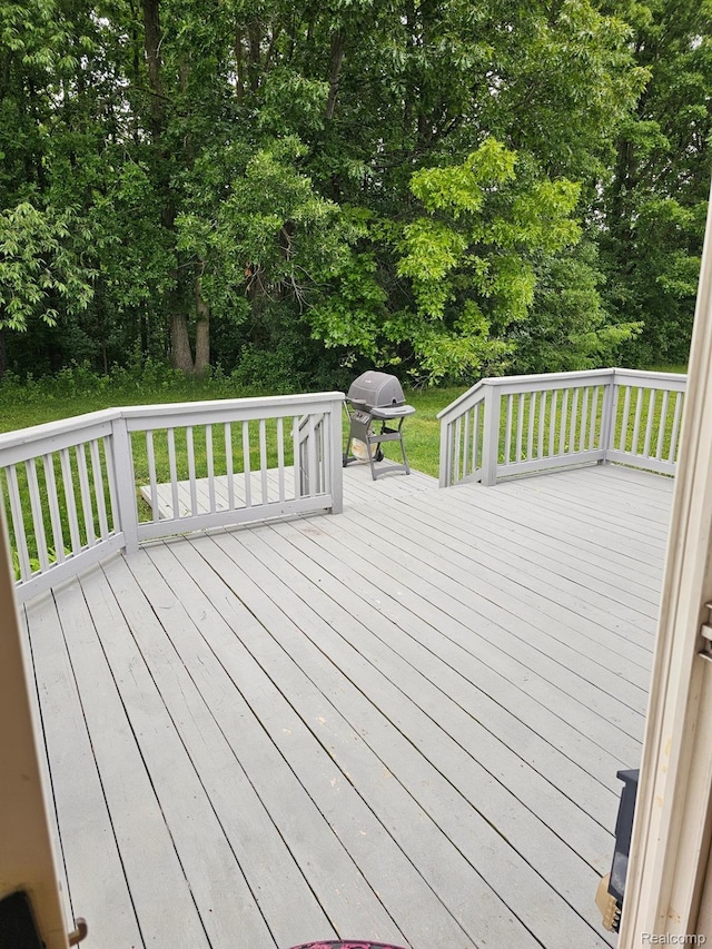 73 Grey Fox Ct, Grand Blanc, MI 48439 - wooden deck featuring a grill and view of scattered trees