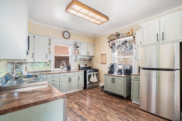 28 Orchard Pl, Battle Creek, MI 49017 - kitchen with open shelves, crown molding, tasteful backsplash, and appliances with stainless steel finishes