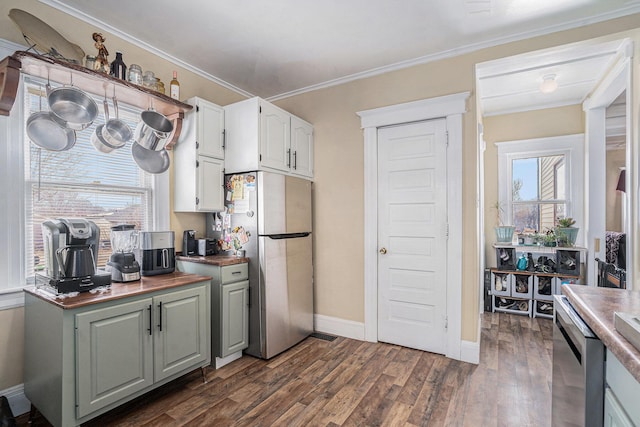 28 Orchard Pl, Battle Creek, MI 49017 - kitchen featuring baseboards, ornamental molding, appliances with stainless steel finishes, white cabinets, and dark wood-style flooring
