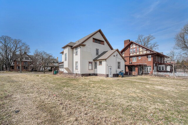 28 Orchard Pl, Battle Creek, MI 49017 - rear view of property with a lawn and a chimney