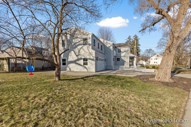 exterior space featuring a residential view, an attached garage, and concrete driveway