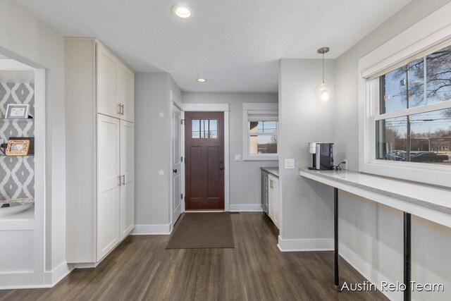 foyer entrance featuring recessed lighting, baseboards, and dark wood-style flooring