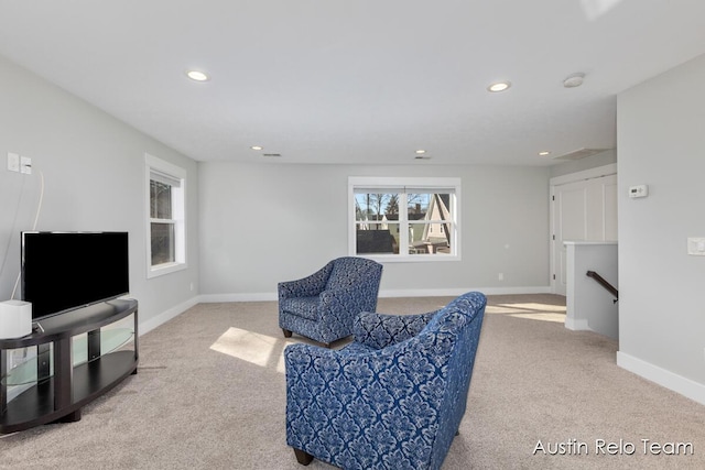 sitting room with an upstairs landing, recessed lighting, carpet, and baseboards