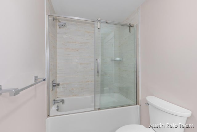 bathroom featuring enclosed tub / shower combo and toilet