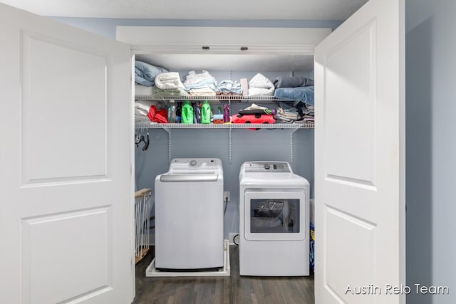 washroom with washer and clothes dryer, laundry area, and wood finished floors