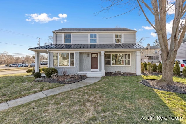 traditional home featuring brick siding, metal roof, and a standing seam roof