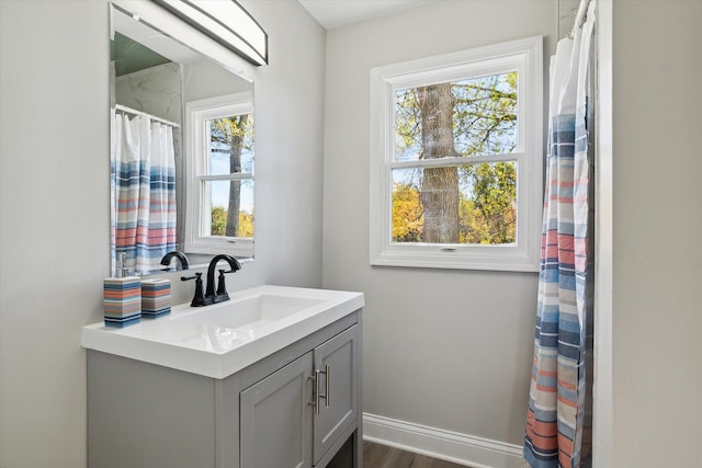 bathroom with baseboards and vanity