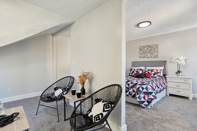 bedroom featuring a textured ceiling, baseboards, and carpet floors