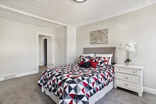 bedroom featuring baseboards, visible vents, carpet floors, and a textured ceiling