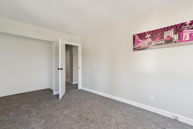 carpeted empty room with baseboards