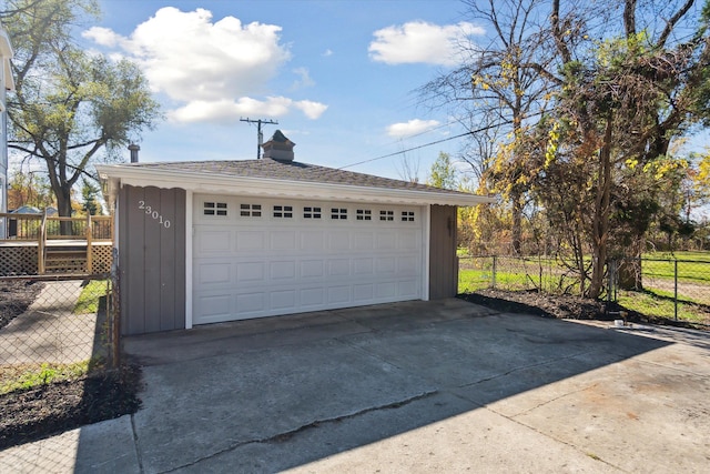 detached garage featuring fence