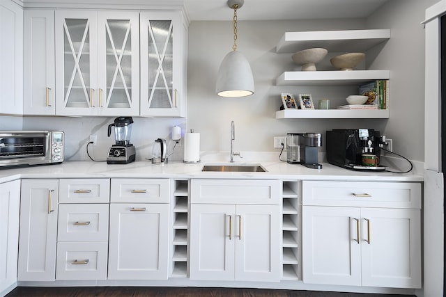 interior space featuring decorative light fixtures, a toaster, and a sink