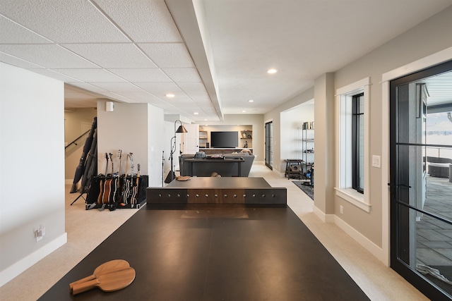 exercise area with recessed lighting, a paneled ceiling, baseboards, and carpet