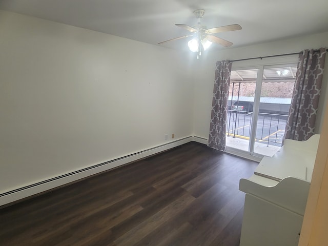 unfurnished room featuring dark wood-type flooring, baseboard heating, and a ceiling fan
