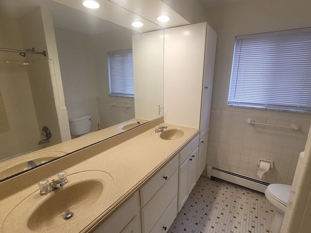 full bathroom featuring a sink, toilet, and a baseboard radiator