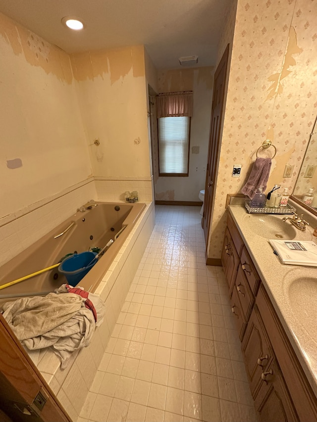 full bath featuring a jetted tub, wallpapered walls, toilet, double vanity, and a sink