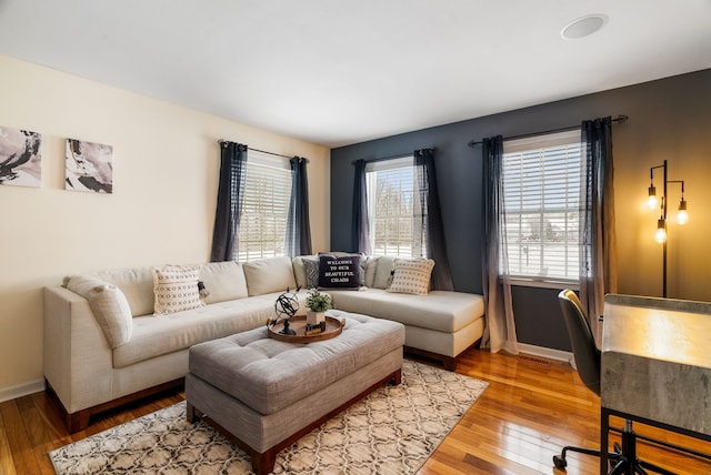 living area featuring wood-type flooring and baseboards