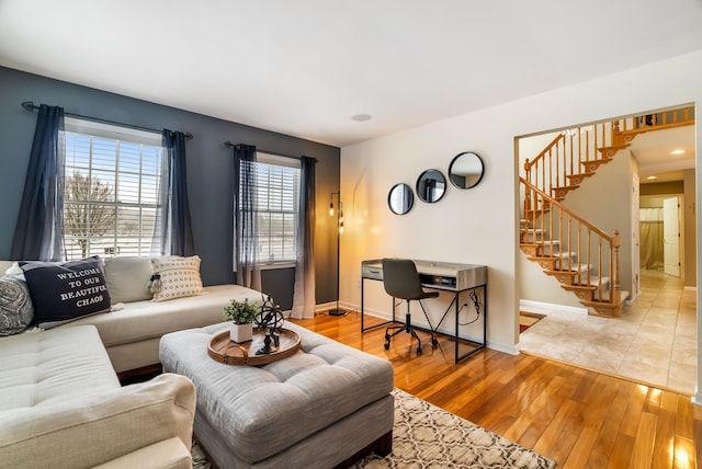 living room with baseboards, recessed lighting, light wood-style flooring, and stairway