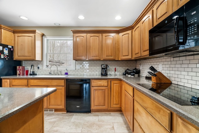 kitchen featuring backsplash, recessed lighting, a sink, and black appliances