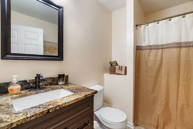 bathroom with vanity, a shower with curtain, and toilet