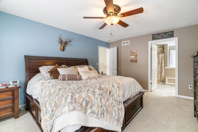 bedroom featuring connected bathroom, ceiling fan, light carpet, baseboards, and visible vents