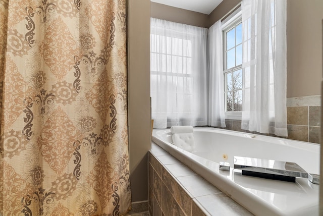 bathroom featuring a tub with jets