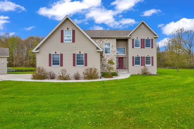 traditional-style house featuring stone siding and a front lawn