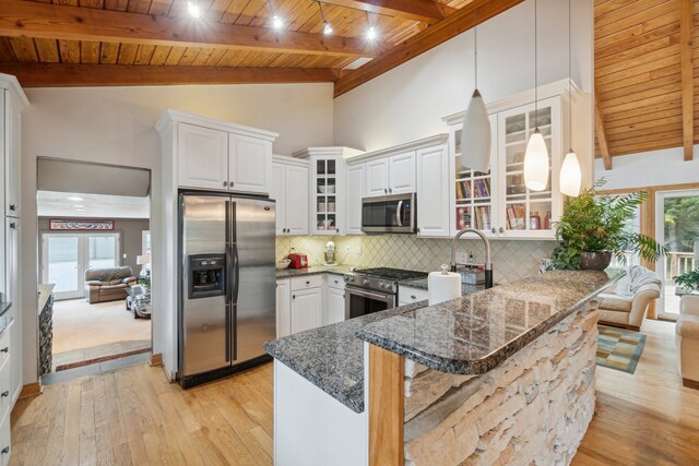 9247 Schrepfer Rd, Howell, MI 48855 - kitchen with wooden ceiling, appliances with stainless steel finishes, beamed ceiling, and a peninsula