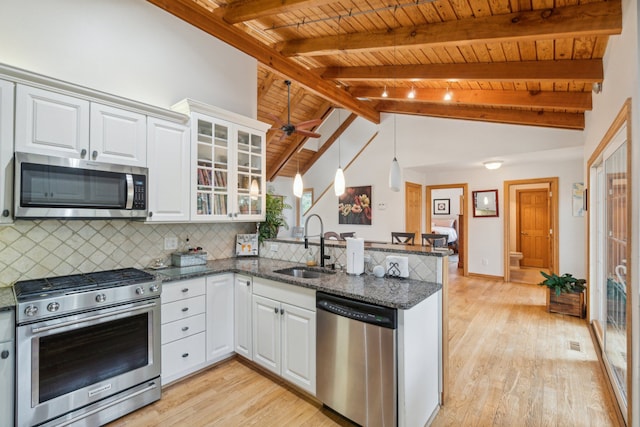 9247 Schrepfer Rd, Howell, MI 48855 - kitchen with a peninsula, light wood-type flooring, wood ceiling, a sink, and stainless steel appliances