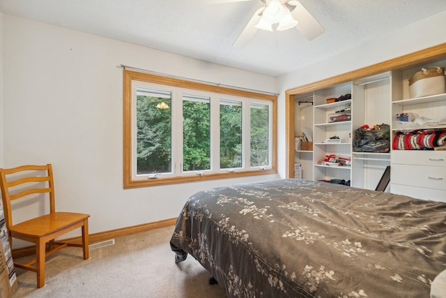 9247 Schrepfer Rd, Howell, MI 48855 - carpeted bedroom with baseboards, visible vents, ceiling fan, and a closet