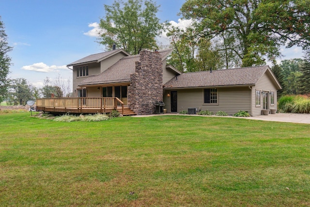 9247 Schrepfer Rd, Howell, MI 48855 - back of house with a lawn, a chimney, a shingled roof, and a wooden deck