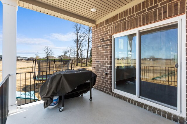 view of patio / terrace featuring a grill and a trampoline