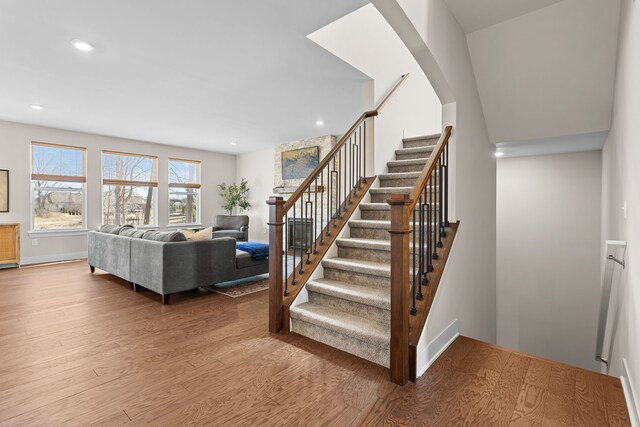 stairs featuring recessed lighting, baseboards, and wood finished floors