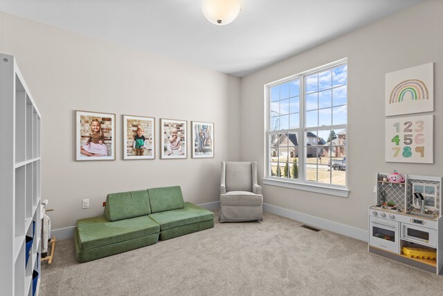 sitting room featuring visible vents, baseboards, and carpet
