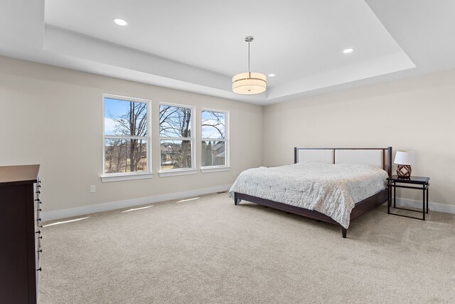 bedroom with recessed lighting, carpet, a raised ceiling, and baseboards