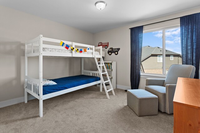 bedroom featuring carpet and baseboards