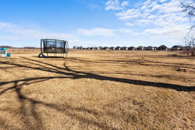 view of yard with a trampoline