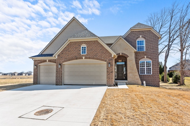 view of front facade with brick siding, concrete driveway, a garage, and a shingled roof