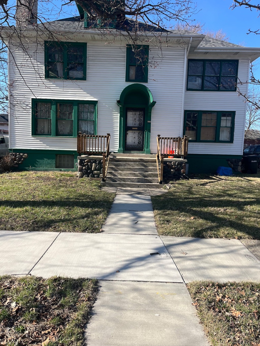 628 Taylor St, Detroit, MI 48202 - doorway to property featuring a lawn and a chimney