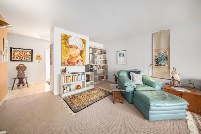 living area featuring tile patterned floors, carpet flooring, and baseboards
