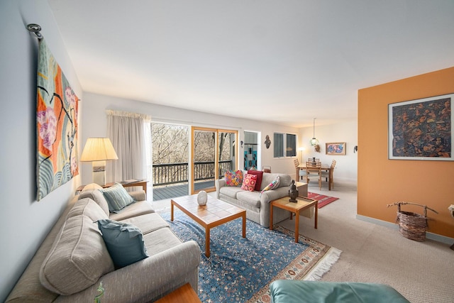 carpeted living room with baseboards