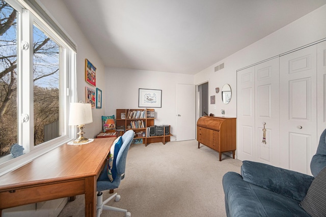 office space featuring visible vents and light carpet