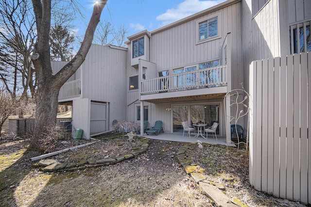 rear view of house featuring a patio area and a balcony