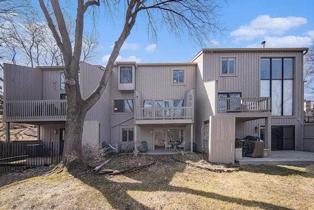 back of house with a patio and fence